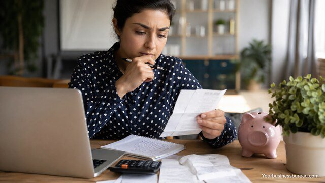 woman analyzing financial habits with receipts and calculator