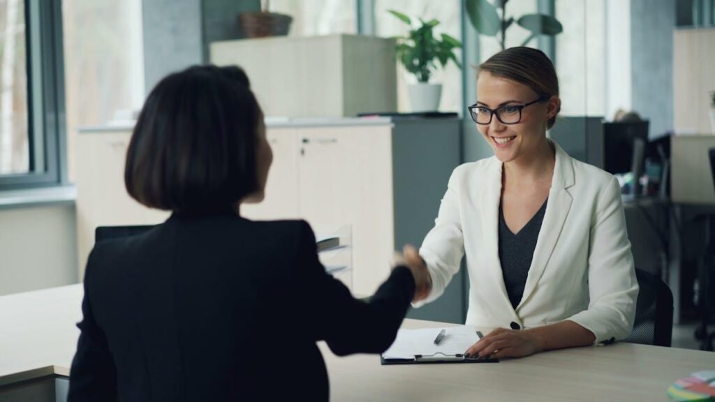 B2B Enterprise Geo Agency: Services for Modern Mapping Business consultant shaking hands with a client during a professional office meeting