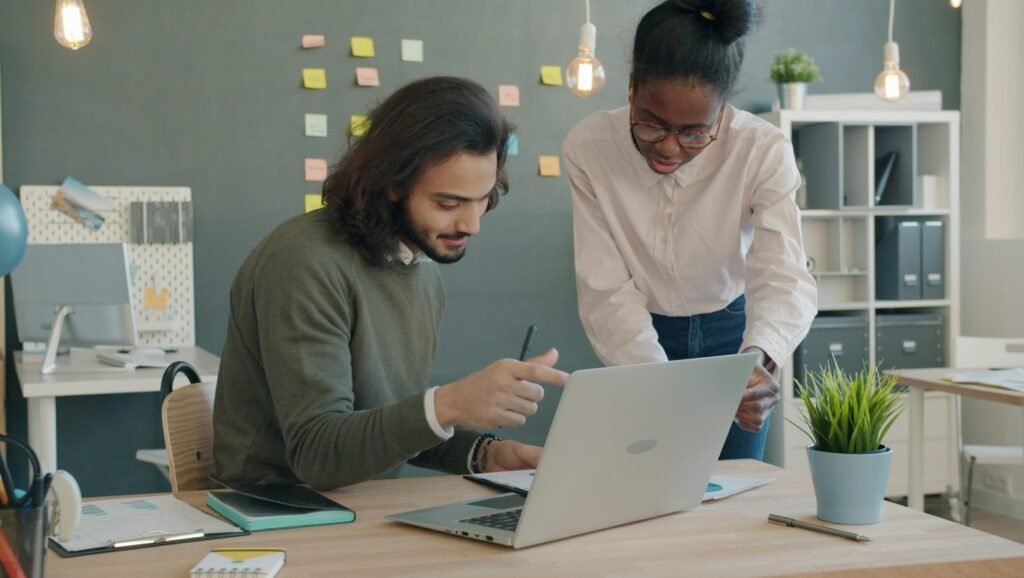 From Policy to Progress: How Upskilling Empowers Policy Analysts to Drive Better Outcomes Policy analysts collaborating on a laptop to improve outcomes through upskilling