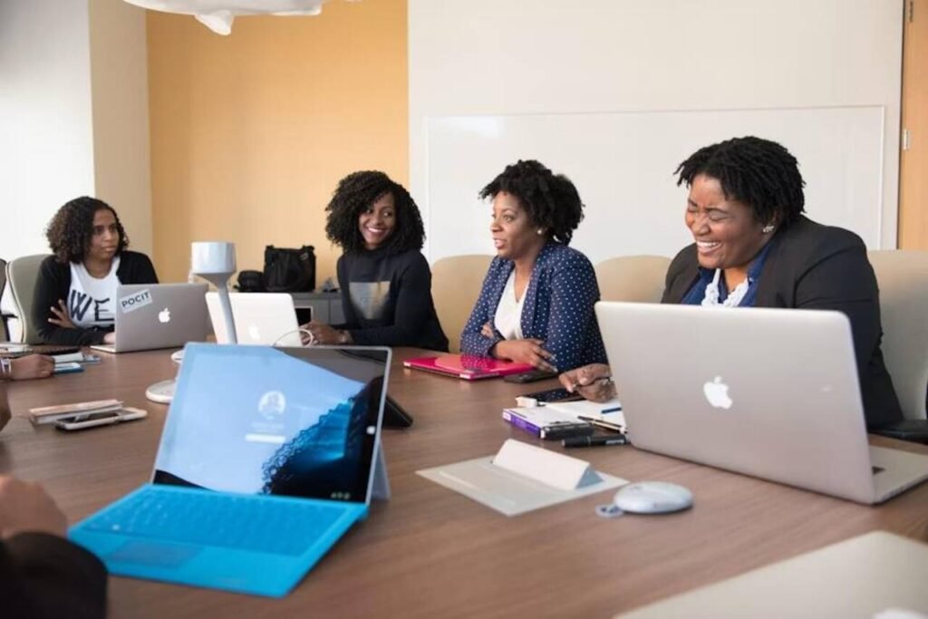 How Employers Benefit When Team Members Pursue Advanced Studies Employees collaborating in a meeting while pursuing professional development
