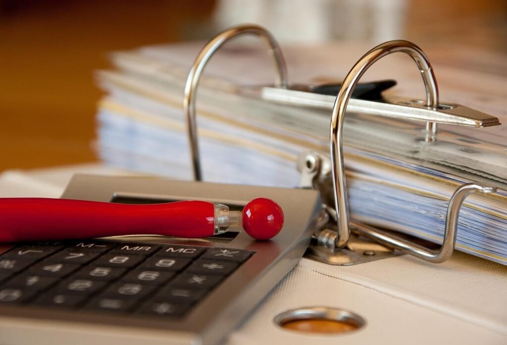 Calculator and financial documents for small business invoicing and accounts receivable management