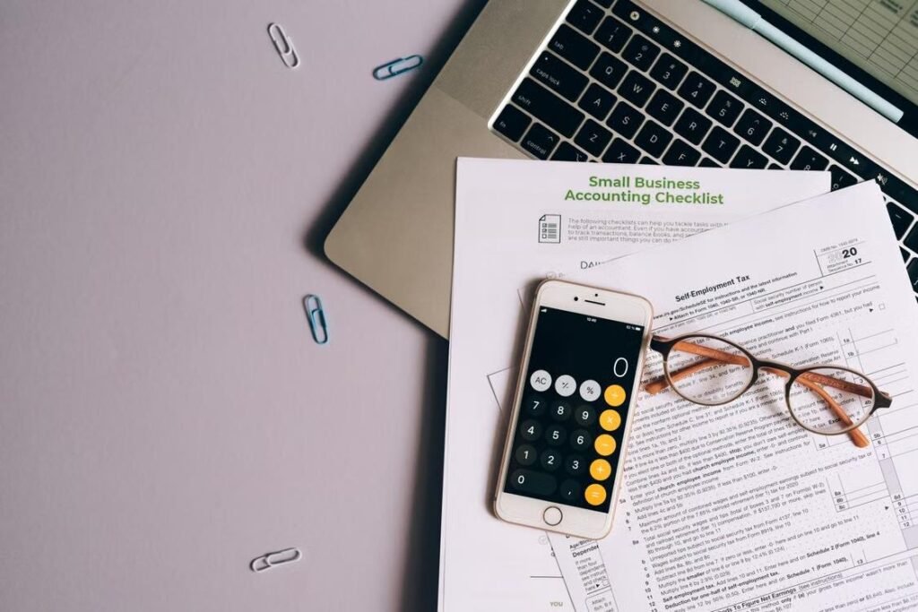 Collateral Requirements for Small Business Financing: What Counts and What Lenders Accept Small business financing documents with calculator, laptop, and tax forms.